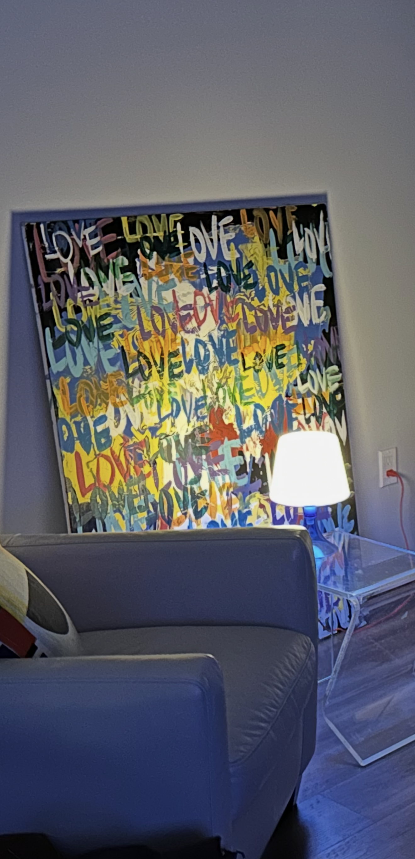 The same canvas hung above a sofa in a living room.