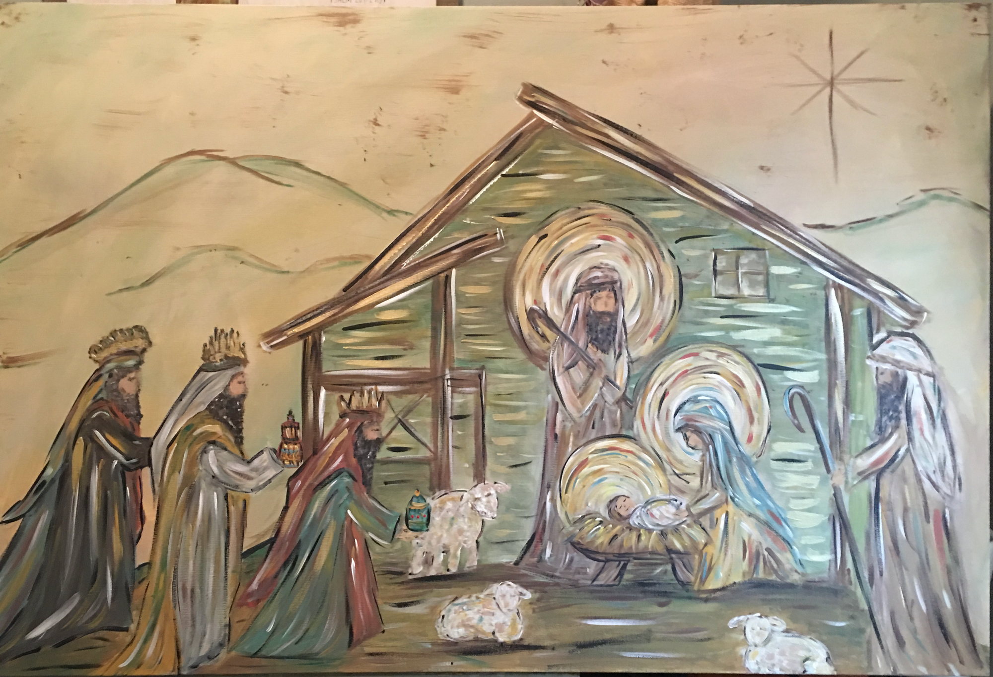 The nativity with three kings approaching a stable, in sage, ochre and cream on a wide canvas.